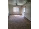 Neutral carpeted living room with a ceiling fan, window, and glass sliding door at 8324 W Charleston Blvd # 2033, Las Vegas, NV 89117