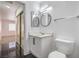 Bathroom with dark tile flooring, modern vanity, and mirrors at 8469 Sewards Bluff Ave, Las Vegas, NV 89129