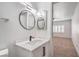 Modern bathroom vanity features round mirrors, modern faucet, and contemporary lighting at 8469 Sewards Bluff Ave, Las Vegas, NV 89129