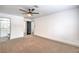 Spacious bedroom featuring ceiling fan, neutral carpet, and an attached bathroom at 8469 Sewards Bluff Ave, Las Vegas, NV 89129