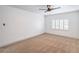 Bright bedroom with neutral carpet, ceiling fan, and shuttered windows at 8469 Sewards Bluff Ave, Las Vegas, NV 89129