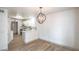 Open-concept dining area with modern chandelier and view of updated kitchen space at 8469 Sewards Bluff Ave, Las Vegas, NV 89129