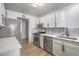 Well-lit kitchen featuring stainless steel appliances, white cabinets, and quartz countertops at 8469 Sewards Bluff Ave, Las Vegas, NV 89129