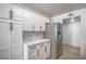 Kitchen features stainless steel appliances, white cabinets, and gray backsplash at 8469 Sewards Bluff Ave, Las Vegas, NV 89129
