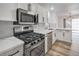 Modern kitchen boasting stainless steel appliances, white cabinetry and quartz countertops at 8469 Sewards Bluff Ave, Las Vegas, NV 89129