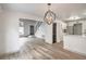 Open-concept living room with hardwood floors, stairs, and view to the updated kitchen at 8469 Sewards Bluff Ave, Las Vegas, NV 89129