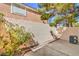 Enclosed patio area with privacy wall, bordered with rock and mature landscaping at 8469 Sewards Bluff Ave, Las Vegas, NV 89129