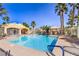 Community pool surrounded by lounge chairs and lush palm trees, perfect for relaxation at 8469 Sewards Bluff Ave, Las Vegas, NV 89129