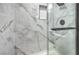 Modern shower featuring marble-look tile, built-in niche, and sleek fixtures at 8469 Sewards Bluff Ave, Las Vegas, NV 89129