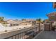 Balcony view of a residential street, neighborhood homes, and desert landscape at 8809 Barium Rock Ave, Las Vegas, NV 89143