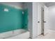 The bathroom has a bathtub and white cabinets at 8809 Barium Rock Ave, Las Vegas, NV 89143