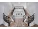 Elegant entryway featuring dual winding staircases and large windows at 8809 Barium Rock Ave, Las Vegas, NV 89143
