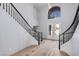Grand entryway with a staircase featuring dark railings and a large window at 8809 Barium Rock Ave, Las Vegas, NV 89143