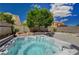 Backyard featuring a hot tub and mature landscaping at 9012 Old River Ave, Las Vegas, NV 89149