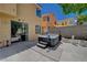 Backyard patio with access to the house through sliding glass doors, featuring a hot tub, statues, and ample space at 9012 Old River Ave, Las Vegas, NV 89149