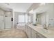 Bright bathroom with a soaking tub, double sinks, and a glass-enclosed shower at 9012 Old River Ave, Las Vegas, NV 89149