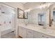 Bright bathroom featuring double sinks, decorative mirrors, and modern lighting at 9012 Old River Ave, Las Vegas, NV 89149