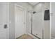 Bathroom featuring a glass enclosed shower and a white door with hooks at 9012 Old River Ave, Las Vegas, NV 89149