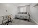 Comfortable bedroom with a large window, desk, neutral decor, and carpet flooring at 9012 Old River Ave, Las Vegas, NV 89149