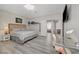 Bedroom with luxury vinyl plank flooring, a desk area, and a queen sized bed at 9012 Old River Ave, Las Vegas, NV 89149