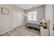 Bedroom with luxury vinyl plank flooring and a twin sized bed by a window at 9012 Old River Ave, Las Vegas, NV 89149