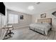 Bedroom with gray walls, work station, and comfortable bed with neutral decor at 9012 Old River Ave, Las Vegas, NV 89149