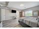 Bedroom with bed, work station, sauna and view into the bathroom at 9012 Old River Ave, Las Vegas, NV 89149