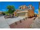 Charming two-story home featuring a well-maintained front yard and attached two-car garage at 9012 Old River Ave, Las Vegas, NV 89149