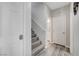 Hallway with stairs and doors leading to other rooms, and wood-look flooring at 9012 Old River Ave, Las Vegas, NV 89149