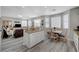 Open concept kitchen and living room, featuring granite countertops, gray laminate floors at 9012 Old River Ave, Las Vegas, NV 89149