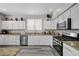 Well-lit kitchen featuring stainless steel appliances, light countertops and backsplash, and ample cabinet space at 9012 Old River Ave, Las Vegas, NV 89149