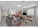 Spacious open-concept living room featuring wood-style flooring, a pool table, bright windows, and comfortable furniture at 9012 Old River Ave, Las Vegas, NV 89149