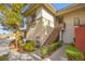 Exterior shot of the apartment with stairs leading up to the second story and green landscape at 913 Duckhorn Ct # 204, Las Vegas, NV 89144