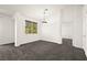 Open concept living room with new carpet, natural light, and neutral paint at 913 Duckhorn Ct # 204, Las Vegas, NV 89144