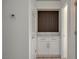 Hallway with a white cabinet, marble countertop, and a decorative wood panel accent wall at 10100 Folsom Dr, Las Vegas, NV 89134