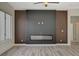 Living room featuring a sleek fireplace, modern wall accents, and plenty of natural light at 10100 Folsom Dr, Las Vegas, NV 89134