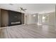 Open-concept living area with sleek hardwood floors, a stylish accent wall, and an abundance of natural light at 10100 Folsom Dr, Las Vegas, NV 89134