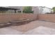 Backyard with gravel, patio, brick wall, and built-in planters for landscaping at 10371 Calypso Cave St, Las Vegas, NV 89141