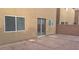 Home's backyard features a concrete patio, gravel, and access to the house via a sliding glass door at 10371 Calypso Cave St, Las Vegas, NV 89141