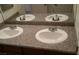 Bathroom featuring granite countertops and dual sinks with modern fixtures at 10371 Calypso Cave St, Las Vegas, NV 89141