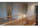 Second floor hallway with wooden railing and view of the stairs at 10371 Calypso Cave St, Las Vegas, NV 89141