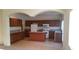 Kitchen featuring brown cabinets, granite countertops, island and stainless steel appliances at 10371 Calypso Cave St, Las Vegas, NV 89141