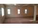 Large living room featuring carpet floors and multiple bright windows for natural light at 10371 Calypso Cave St, Las Vegas, NV 89141