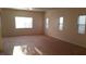 Spacious living room with natural light from large windows and neutral-toned carpet at 10371 Calypso Cave St, Las Vegas, NV 89141