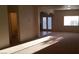 Spacious living room area with natural light and double doors to the exterior at 10371 Calypso Cave St, Las Vegas, NV 89141