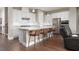 Spacious kitchen with a breakfast bar island, white cabinetry, stainless appliances, and stylish pendant lights at 12310 Tudor Arch Dr, Las Vegas, NV 89138