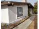 View of a single-story home with stucco siding, a walkway, and exterior lighting at 1413 Bryn Mawr Ave, Las Vegas, NV 89102