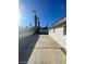 Side exterior view with a long concrete driveway and detached garage at 1413 Bryn Mawr Ave, Las Vegas, NV 89102