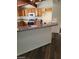 Charming kitchen with a breakfast bar, wooden cabinets, and modern appliances at 1413 Bryn Mawr Ave, Las Vegas, NV 89102