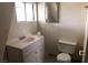 A well-lit bathroom with a toilet, sink, and vanity at 1427 San Felipe Dr, Boulder City, NV 89005